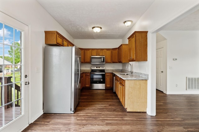 213 Nashua Ct, Murfreesboro, TN 37128 - kitchen featuring a sink, brown cabinetry, appliances with stainless steel finishes, dark wood-style flooring, and visible vents