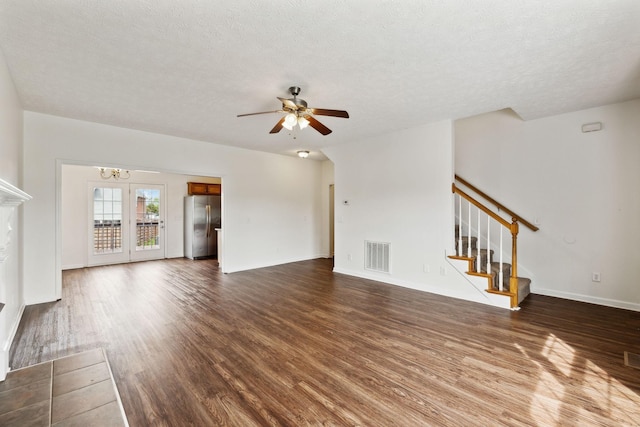 213 Nashua Ct, Murfreesboro, TN 37128 - unfurnished living room featuring ceiling fan with notable chandelier, visible vents, stairs, and dark wood-style flooring