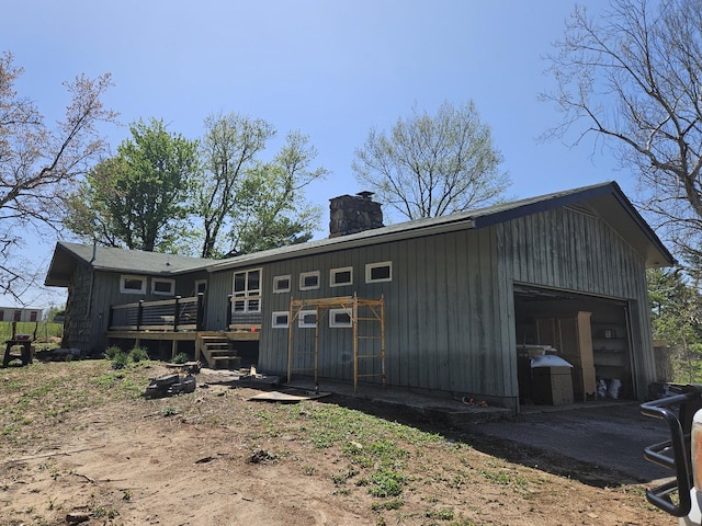 395 Church St, Spencer, TN 38585 - back of property featuring an outbuilding, aphalt driveway, a detached garage, a chimney, and a deck