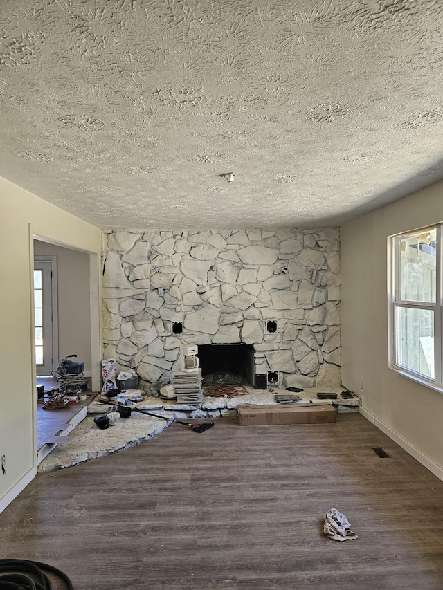 395 Church St, Spencer, TN 38585 - unfurnished living room featuring visible vents, baseboards, a textured ceiling, and wood finished floors