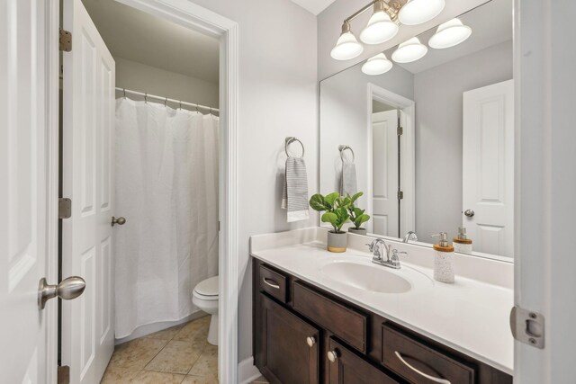 full bath featuring tile patterned flooring, toilet, and vanity