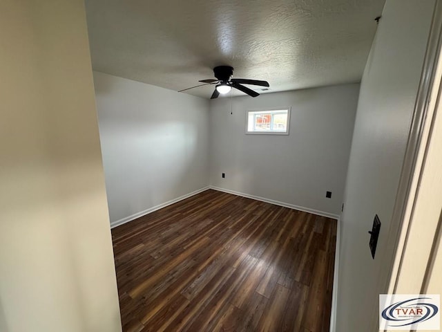 5380 Sulphur Creek Rd, Big Sandy, TN 38221 - unfurnished room with a textured ceiling, baseboards, a ceiling fan, and dark wood finished floors