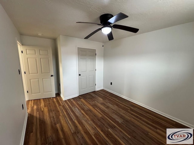 5380 Sulphur Creek Rd, Big Sandy, TN 38221 - unfurnished bedroom with baseboards, a textured ceiling, and dark wood finished floors