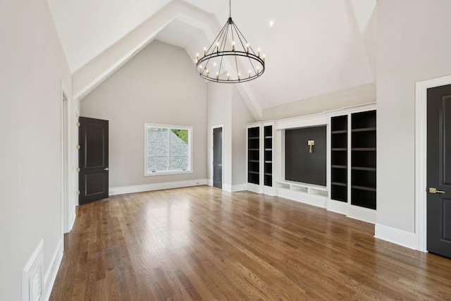 521 Mansion Dr, Brentwood, TN 37027 - unfurnished living room featuring a chandelier, wood finished floors, high vaulted ceiling, and baseboards
