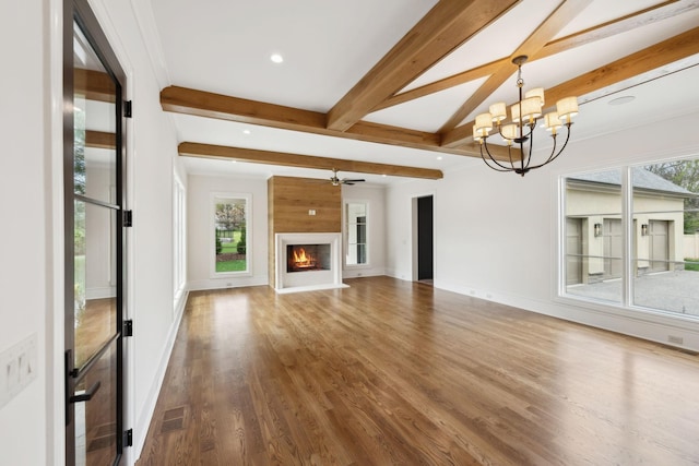 521 Mansion Dr, Brentwood, TN 37027 - unfurnished living room featuring wood finished floors, visible vents, beamed ceiling, and a healthy amount of sunlight