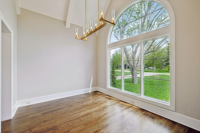 521 Mansion Dr, Brentwood, TN 37027 - unfurnished dining area with visible vents, baseboards, a towering ceiling, and wood finished floors