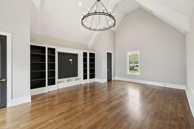 521 Mansion Dr, Brentwood, TN 37027 - unfurnished living room with wood finished floors, an inviting chandelier, baseboards, and high vaulted ceiling