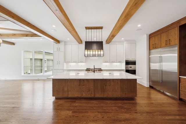 521 Mansion Dr, Brentwood, TN 37027 - kitchen featuring white cabinets, dark wood-type flooring, stainless steel built in fridge, a large island with sink, and a sink