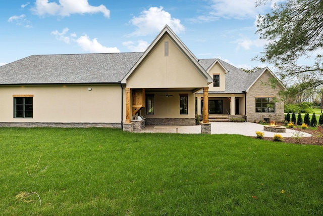 521 Mansion Dr, Brentwood, TN 37027 - rear view of property featuring stone siding, a fire pit, a lawn, and stucco siding