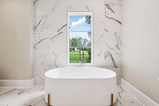 521 Mansion Dr, Brentwood, TN 37027 - bathroom with stone wall, marble finish floor, and a soaking tub