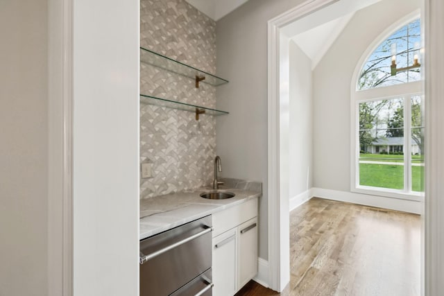 521 Mansion Dr, Brentwood, TN 37027 - bar featuring baseboards, wet bar, stainless steel dishwasher, a sink, and wood finished floors