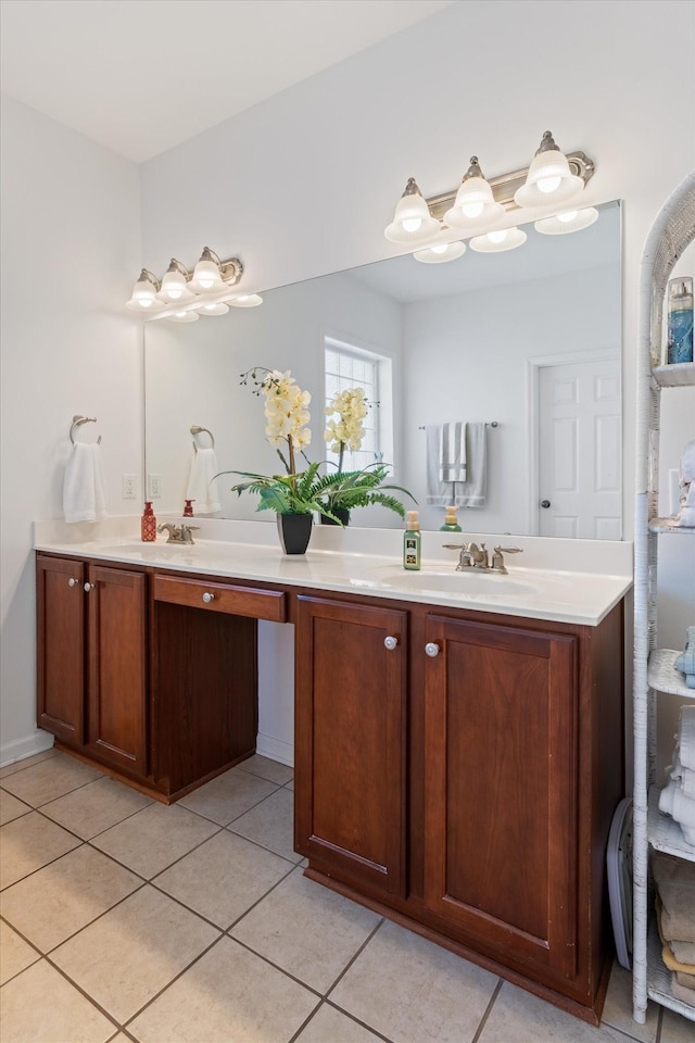 bathroom with tile patterned floors, double vanity, and a sink