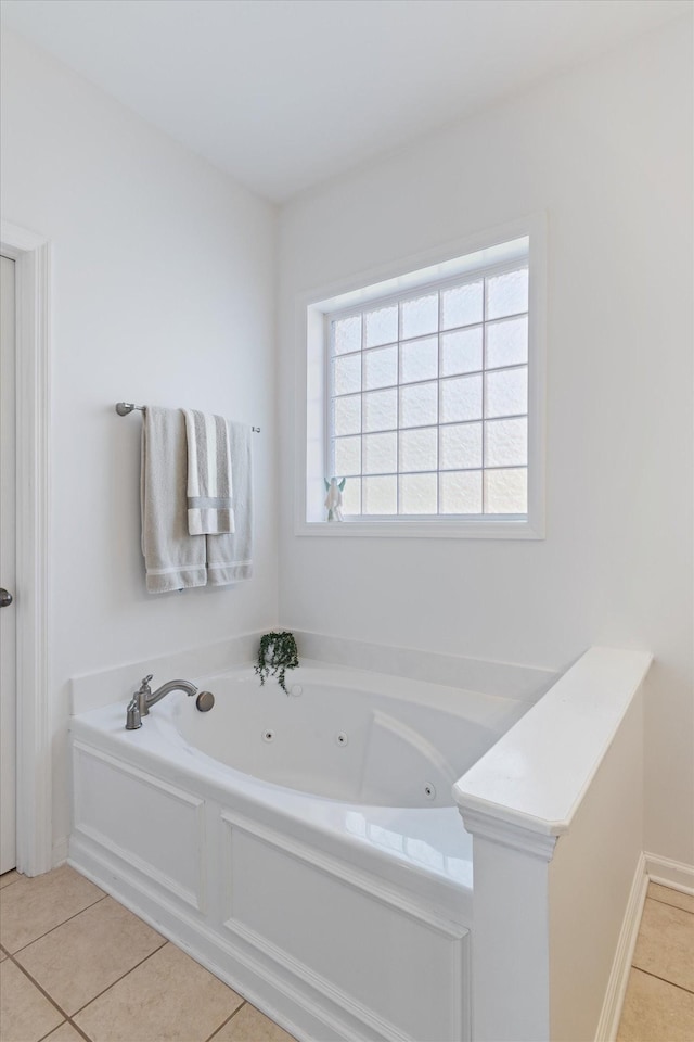 bathroom with tile patterned floors and a whirlpool tub