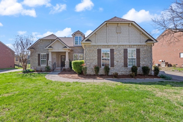 craftsman inspired home with stone siding and a front lawn