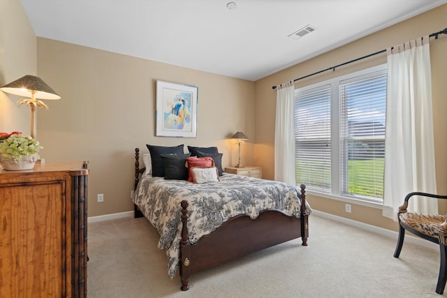 bedroom with light carpet, visible vents, and baseboards