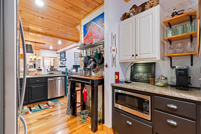 1720 Bratton Ln, Williamsport, TN 38487 - kitchen with white cabinets, light wood-style floors, wood ceiling, light stone countertops, and stainless steel appliances