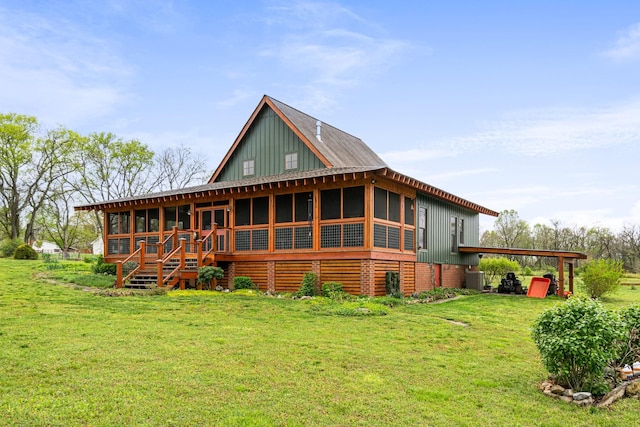 1720 Bratton Ln, Williamsport, TN 38487 - rear view of house featuring central air condition unit, a carport, board and batten siding, and a lawn