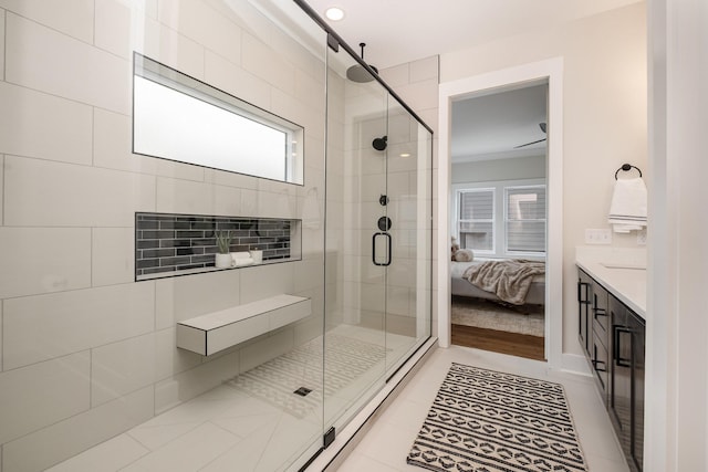 full bath with a stall shower, vanity, tile patterned flooring, and connected bathroom