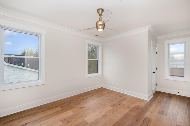 unfurnished room with light wood-type flooring, baseboards, and ornamental molding