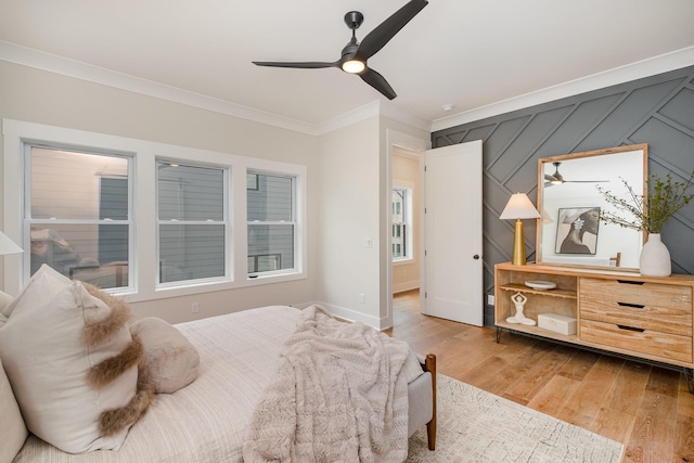 bedroom with wood finished floors, ceiling fan, and ornamental molding