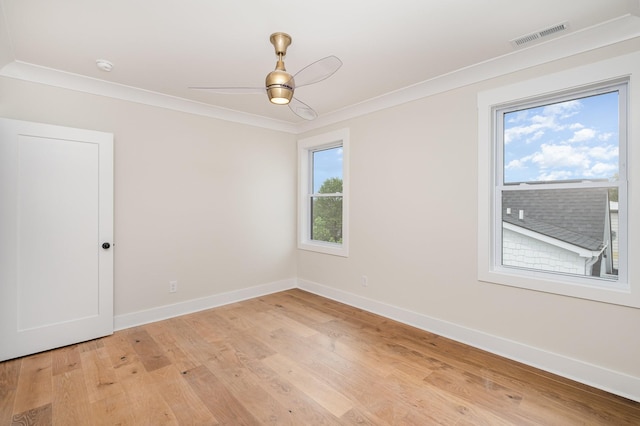 unfurnished room featuring light wood-style flooring, crown molding, and baseboards
