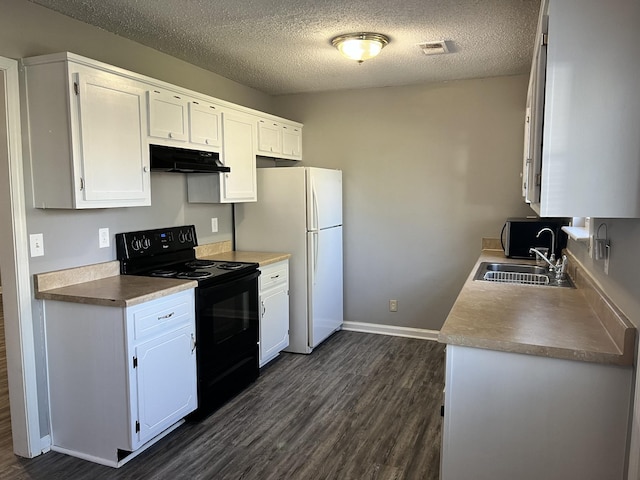kitchen with freestanding refrigerator, dark wood finished floors, under cabinet range hood, a sink, and black / electric stove