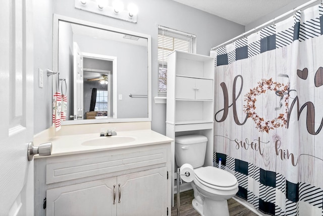 full bath featuring a shower with curtain, toilet, ceiling fan, vanity, and wood finished floors
