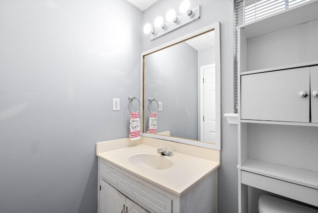 bathroom featuring toilet and vanity
