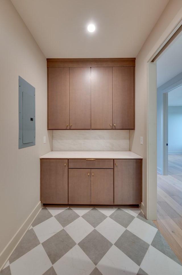 2108 12th Ave S, Nashville, TN 37204 - kitchen with baseboards, light countertops, electric panel, and light floors