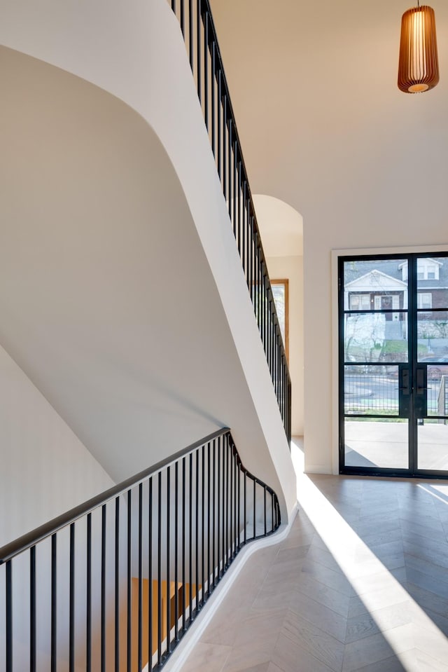 2108 12th Ave S, Nashville, TN 37204 - stairway with arched walkways, french doors, a towering ceiling, and baseboards
