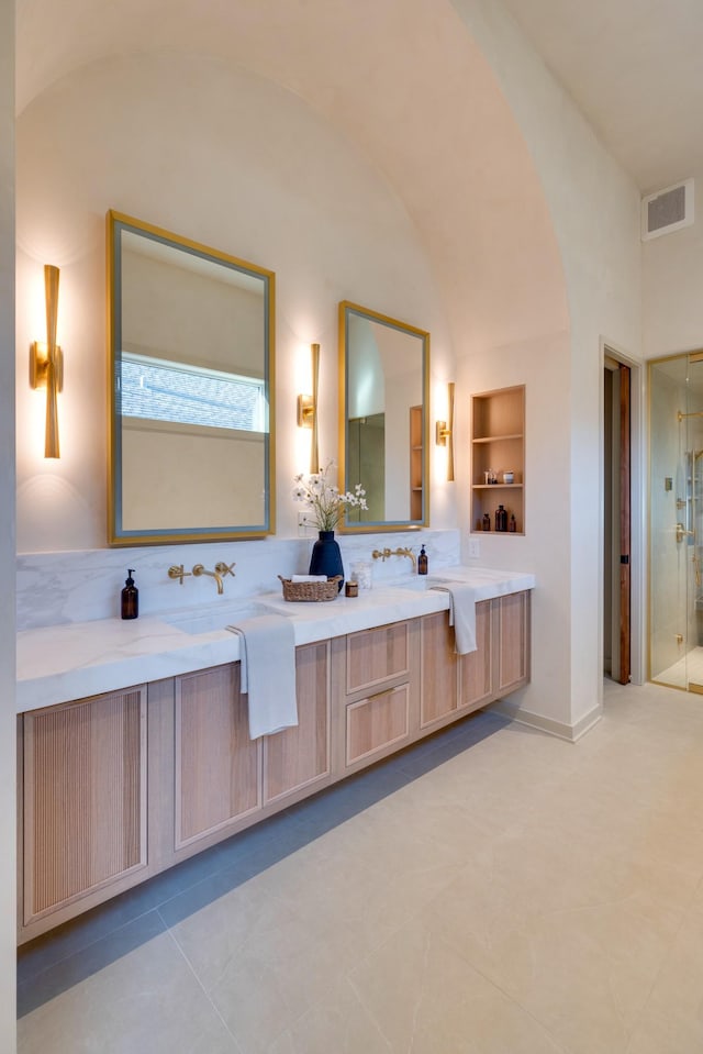 2108 12th Ave S, Nashville, TN 37204 - full bathroom featuring vaulted ceiling, double vanity, a stall shower, visible vents, and built in shelves