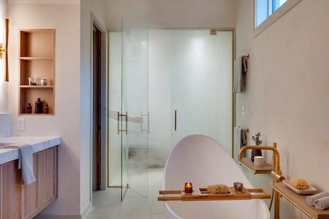 2108 12th Ave S, Nashville, TN 37204 - bathroom featuring vanity, built in features, a stall shower, a soaking tub, and tile patterned floors