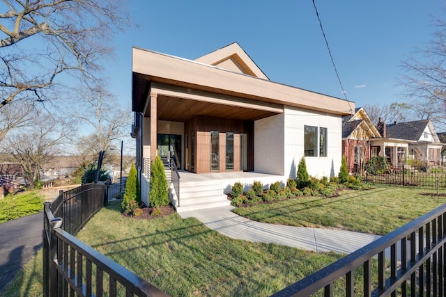 2108 12th Ave S, Nashville, TN 37204 - back of house with a yard, stucco siding, and fence