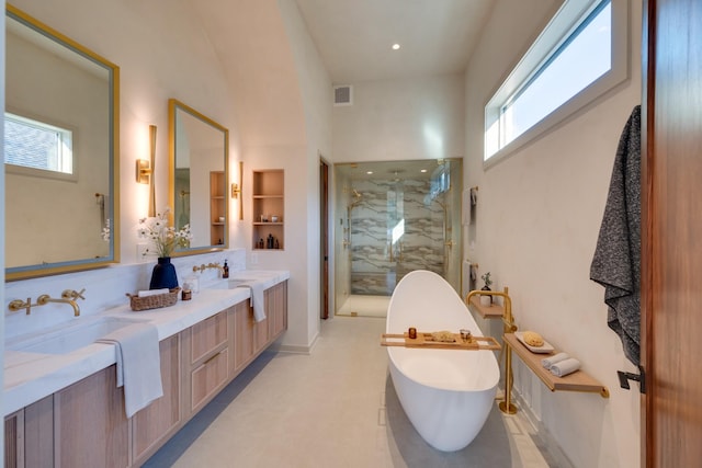 2108 12th Ave S, Nashville, TN 37204 - bathroom featuring visible vents, a freestanding bath, a sink, double vanity, and a marble finish shower