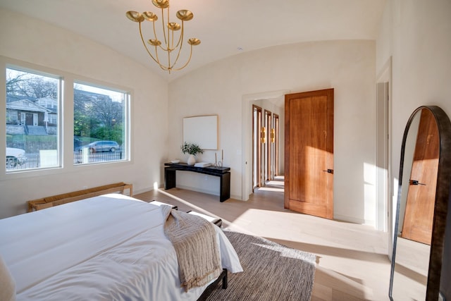 2108 12th Ave S, Nashville, TN 37204 - bedroom with radiator, vaulted ceiling, wood finished floors, baseboards, and a notable chandelier