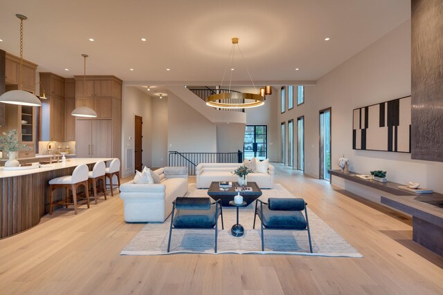 2108 12th Ave S, Nashville, TN 37204 - living room with a notable chandelier, recessed lighting, a high ceiling, and light wood-style floors