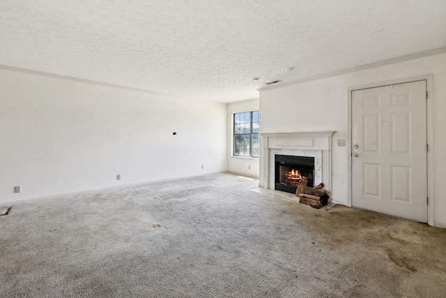 107 Heritage Trace Dr, Madison, TN 37115 - unfurnished living room with baseboards, a textured ceiling, carpet floors, visible vents, and a premium fireplace