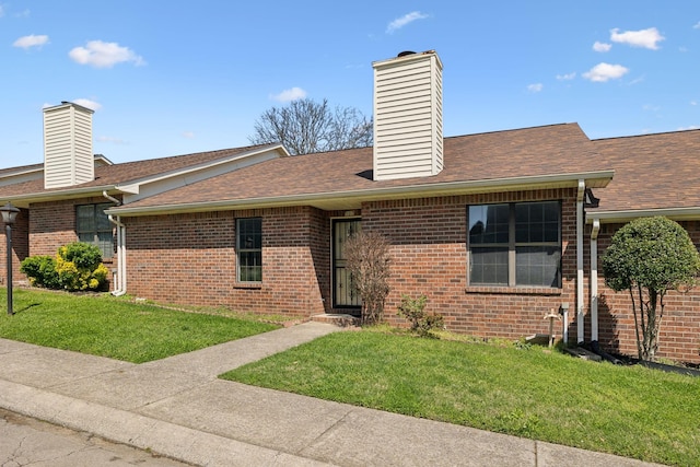 107 Heritage Trace Dr, Madison, TN 37115 - exterior space featuring a yard, roof with shingles, brick siding, and a chimney