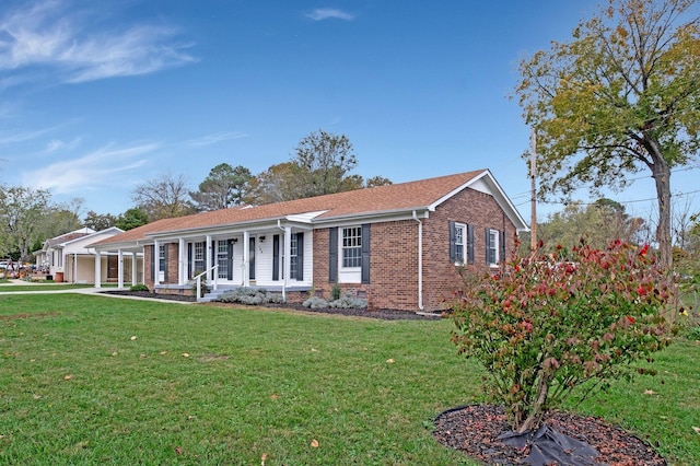 single story home featuring a front lawn, covered porch, and brick siding
