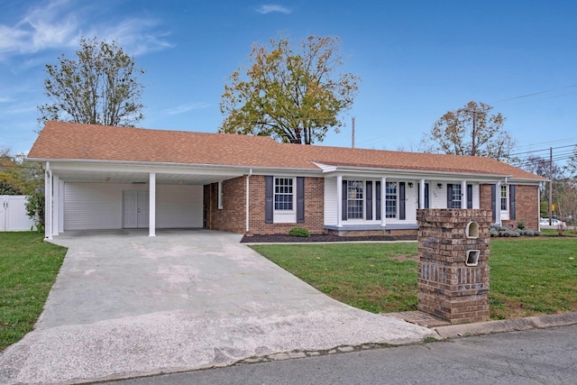 ranch-style house with driveway, a front lawn, fence, and an attached carport