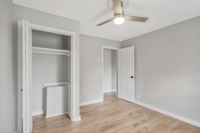 unfurnished bedroom with ceiling fan, baseboards, a closet, and light wood-style flooring