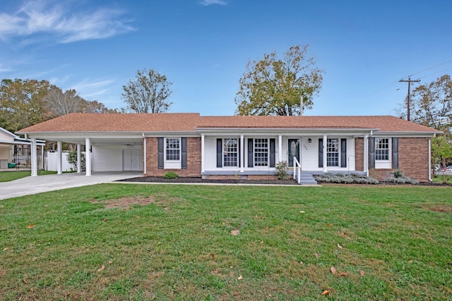 single story home with a carport, driveway, brick siding, and a front yard