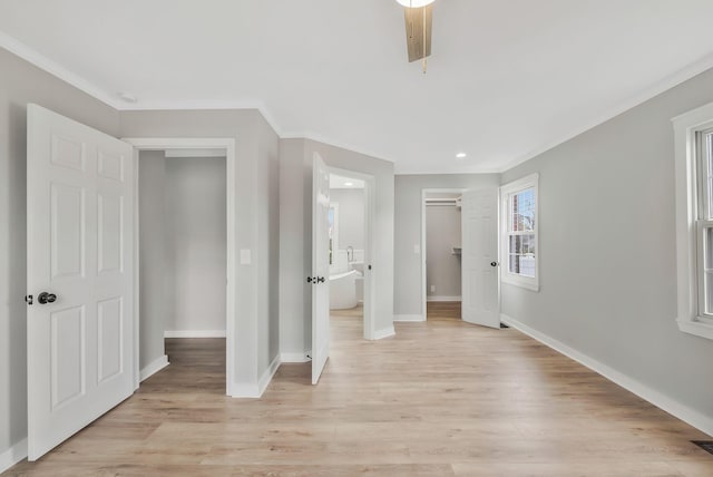 unfurnished bedroom with light wood finished floors, baseboards, visible vents, and crown molding