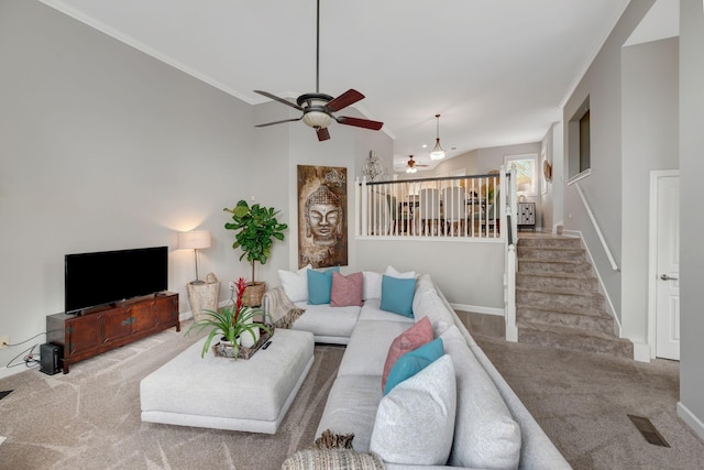 living area featuring visible vents, ceiling fan, stairway, and carpet