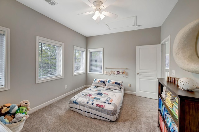 bedroom with visible vents, baseboards, attic access, and carpet floors