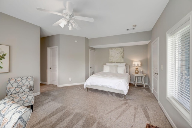 carpeted bedroom featuring ceiling fan, baseboards, and visible vents