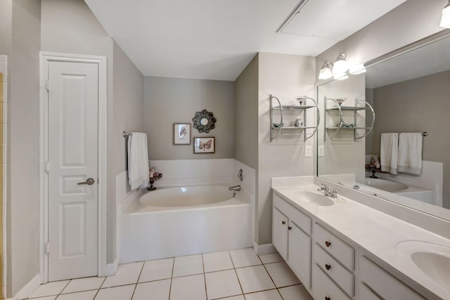 bathroom with tile patterned floors, double vanity, a garden tub, and a sink