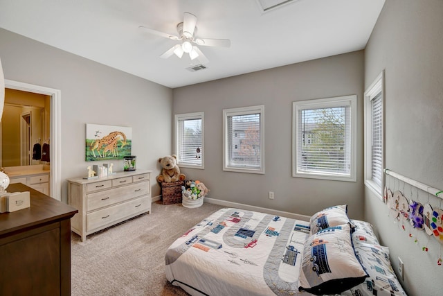 bedroom with baseboards, visible vents, light colored carpet, and multiple windows