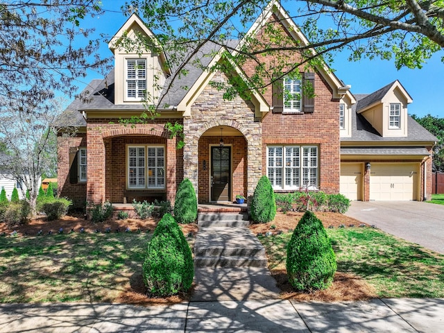 148 Worthy Dr, Franklin, TN 37064 - view of front of property featuring brick siding, driveway, a shingled roof, and covered porch