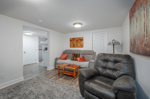 living area featuring baseboards and wood finished floors